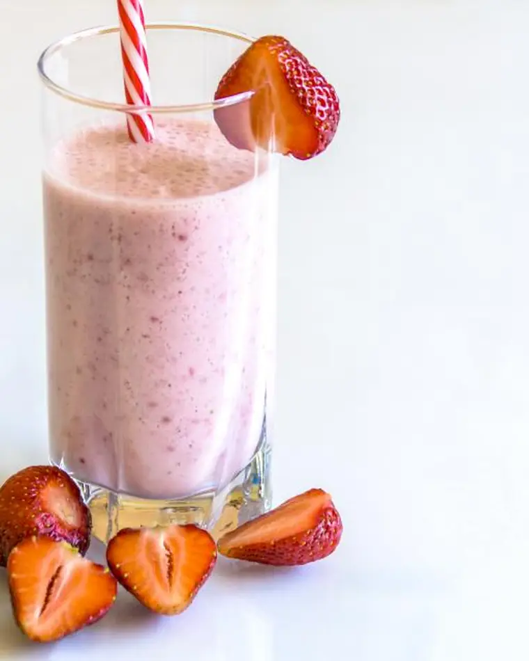 Strawberry milkshake with a striped straw